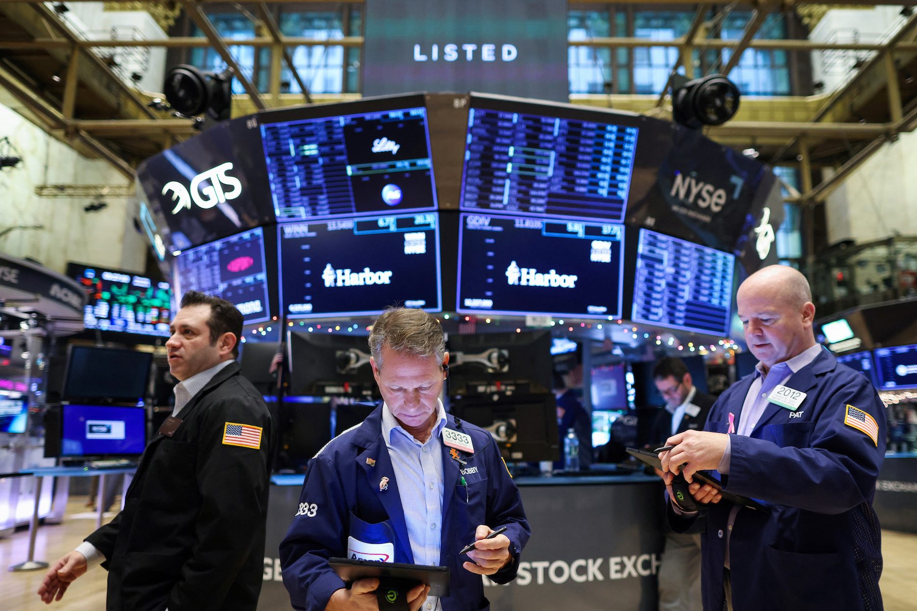 Wall Street trading floor with US stock index screens falling and treasury yields rising