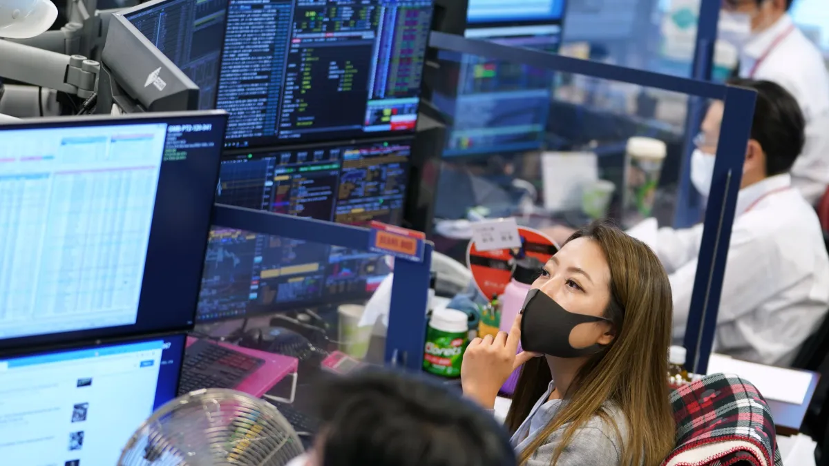 Asian stock trading room displaying semiconductor charts and Chinese inflation data