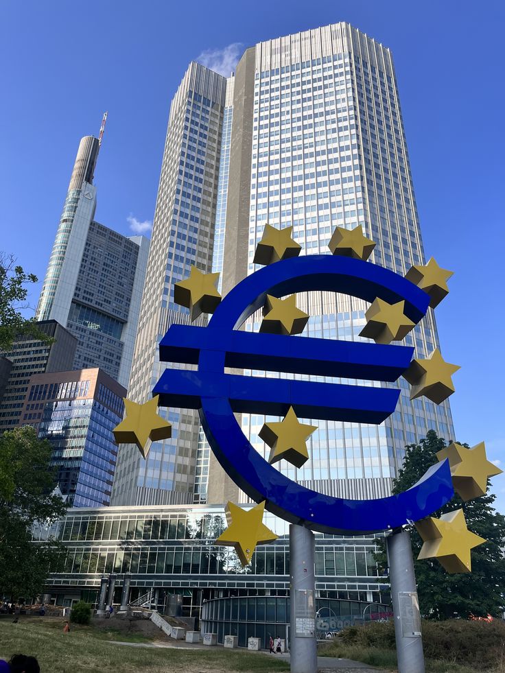 European Central Bank building in Frankfurt with stock market indices plunging