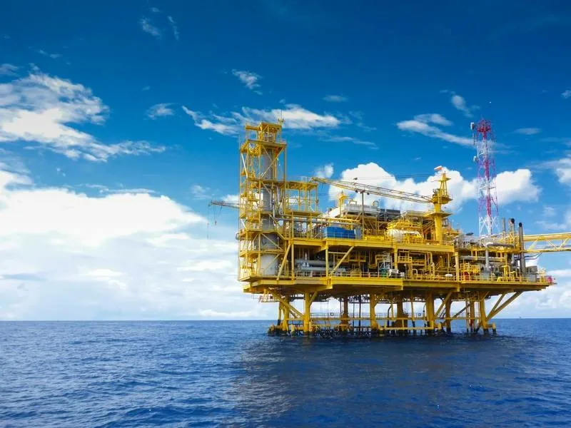 Crude oil offshore rig platform with oil barrel prices chart approaching 100 dollars