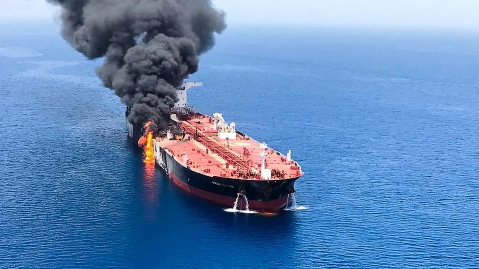 Oil tankers near Strait of Hormuz with crude oil price chart climbing to 98 dollars
